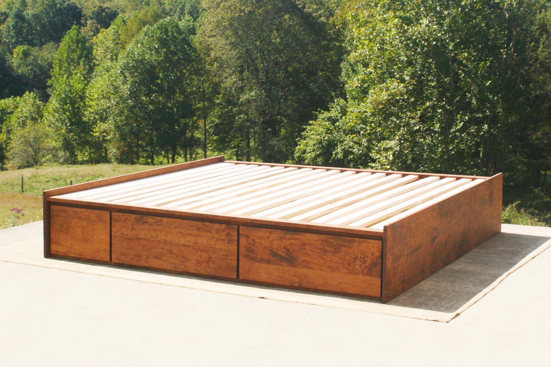 angled view natural platform bed with drawers