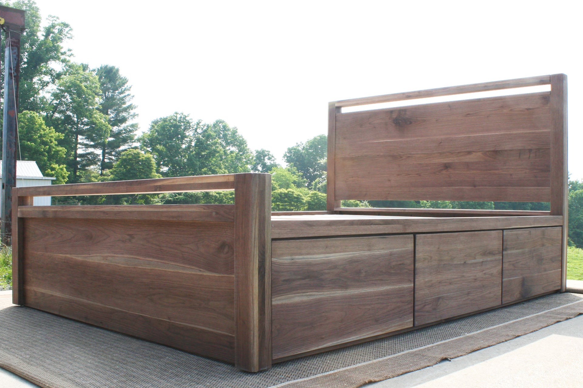 low angled view Storage Bed with top-rail head and footboard