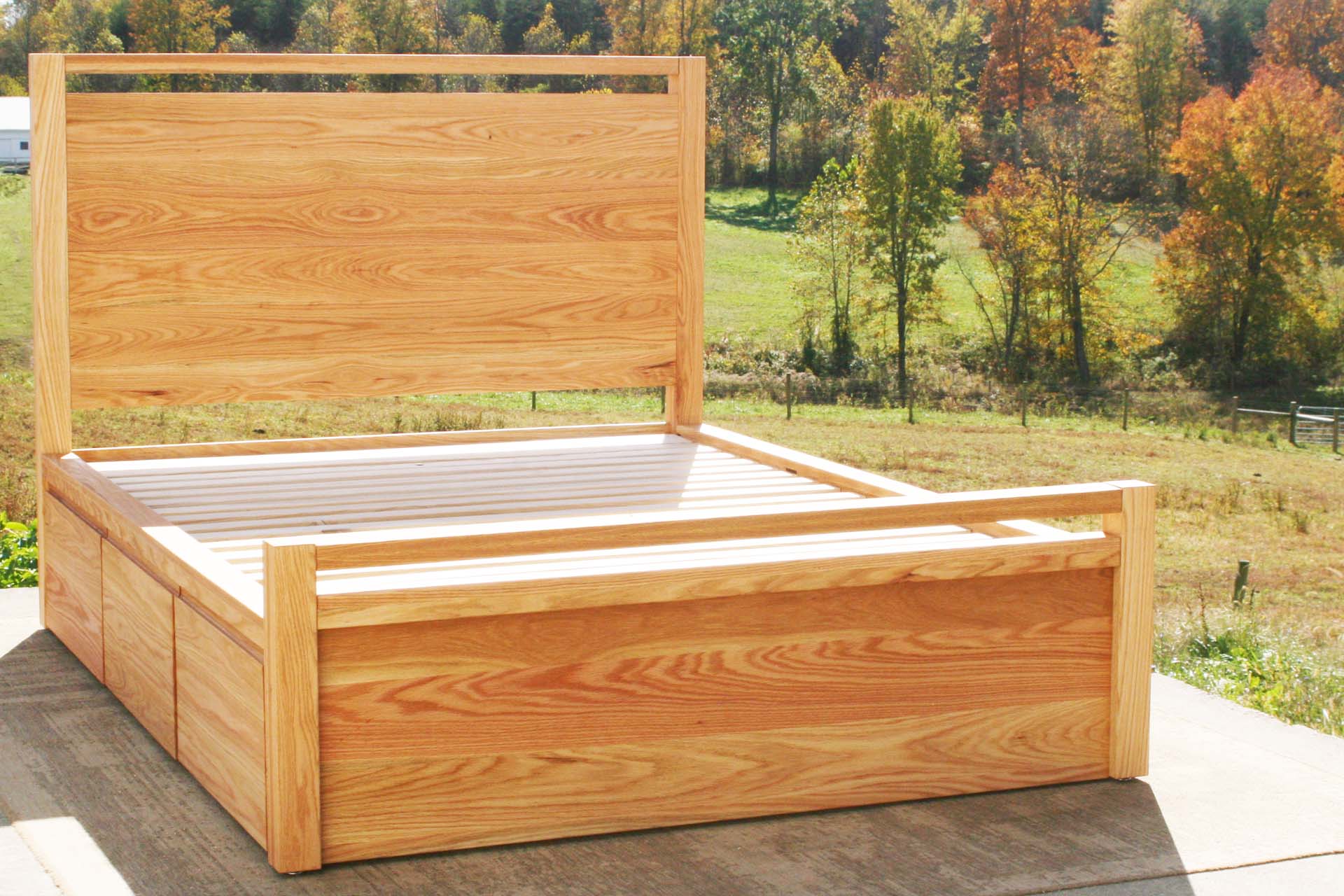 angled view custom Storage Bed with top-rail head and footboard