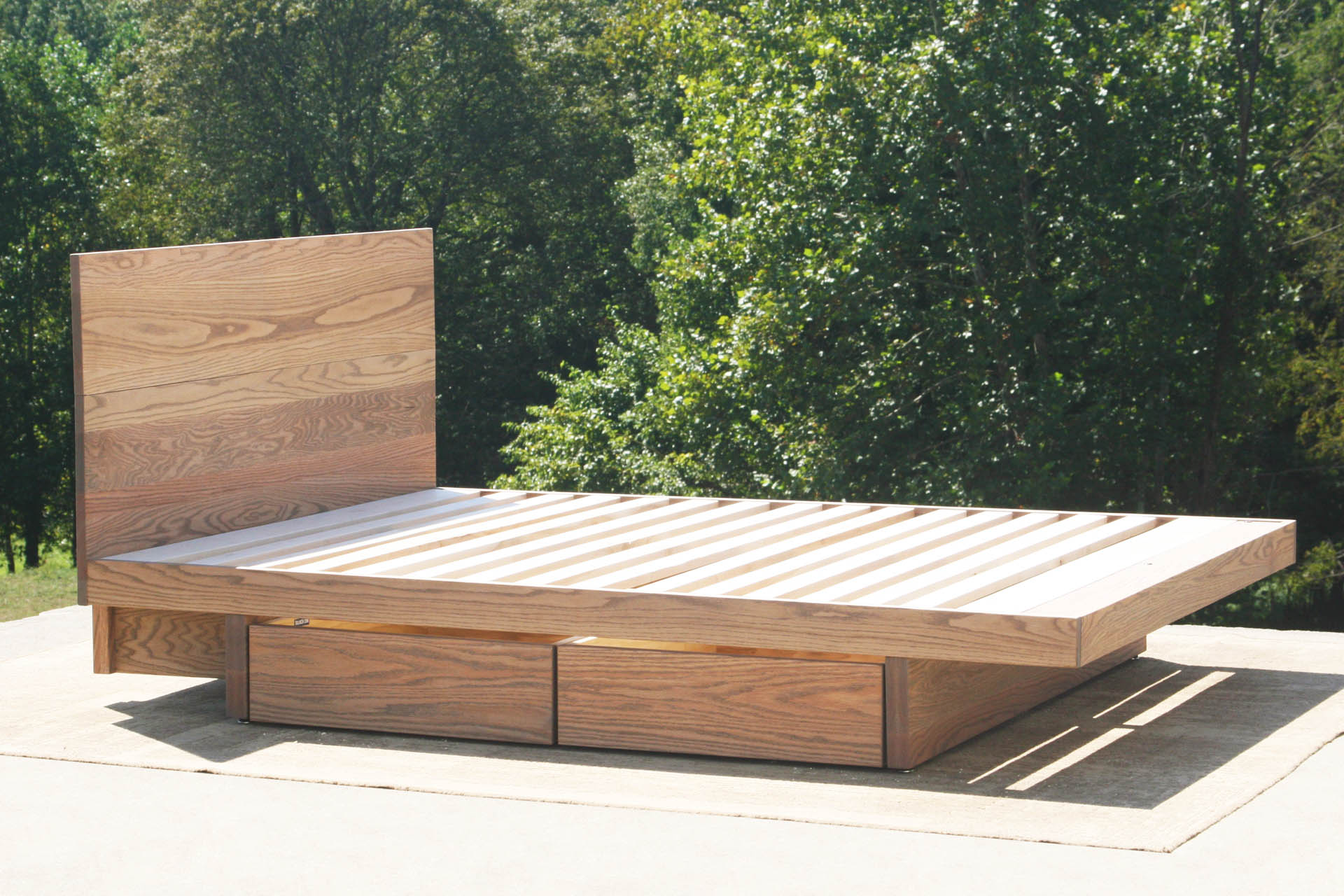 angled view custom Cantilever storage bed with 4 drawers and headboard