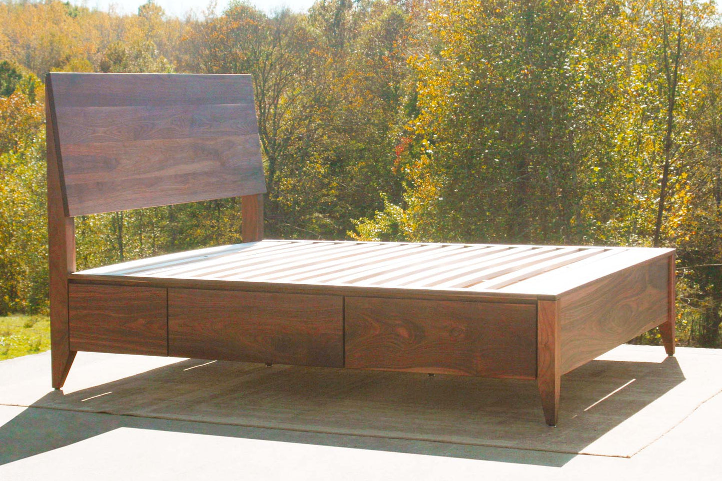 angled view custom Platform storage bed with headboard