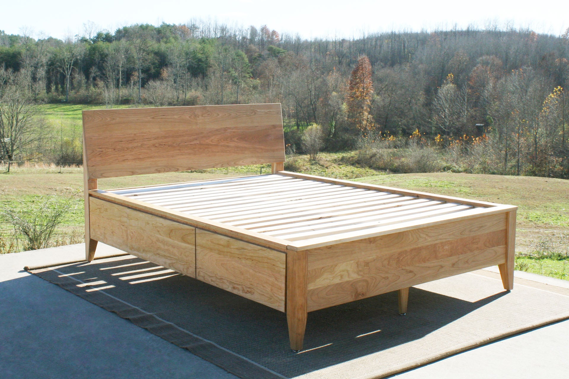 angled view wood Platform storage bed with headboard
