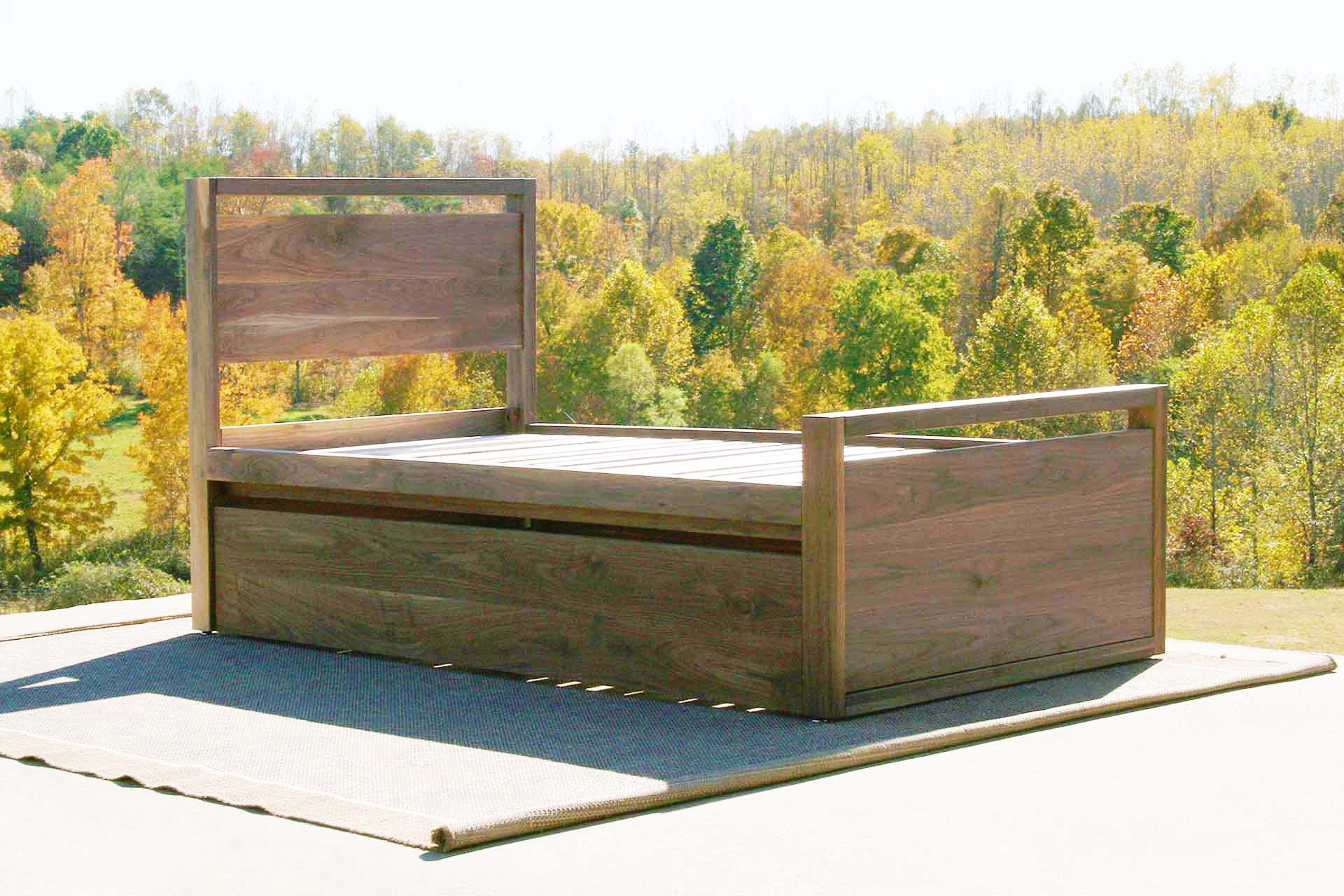 angled view natural Trundle Bed with top rails on headboard and footboard