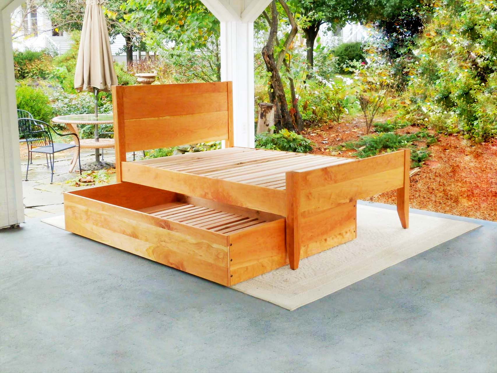 angled view Trundle Bed with headboard and footboard trundle half pulled out