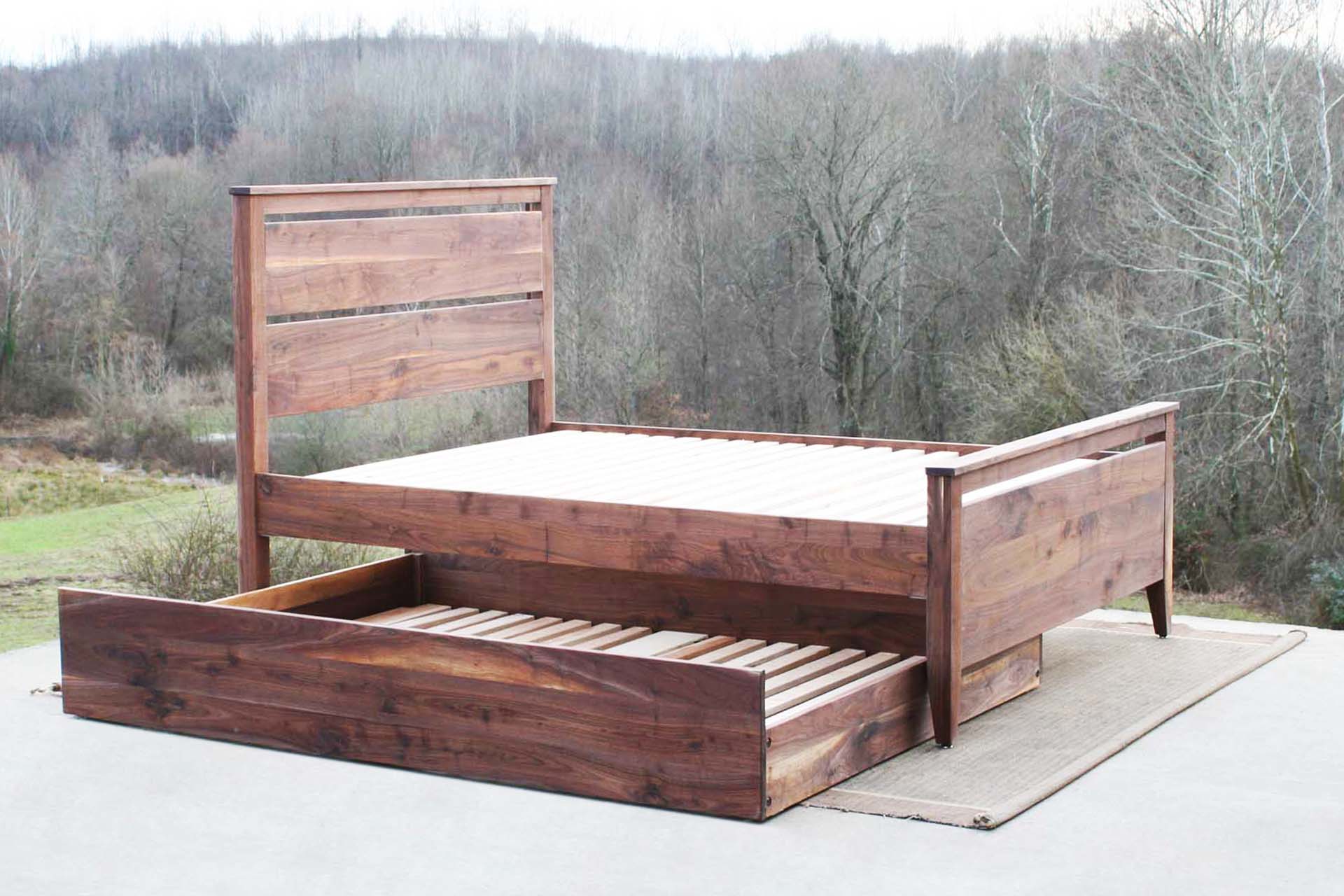 side view walnut Trundle Bed with headboard and footboard trundle partly out