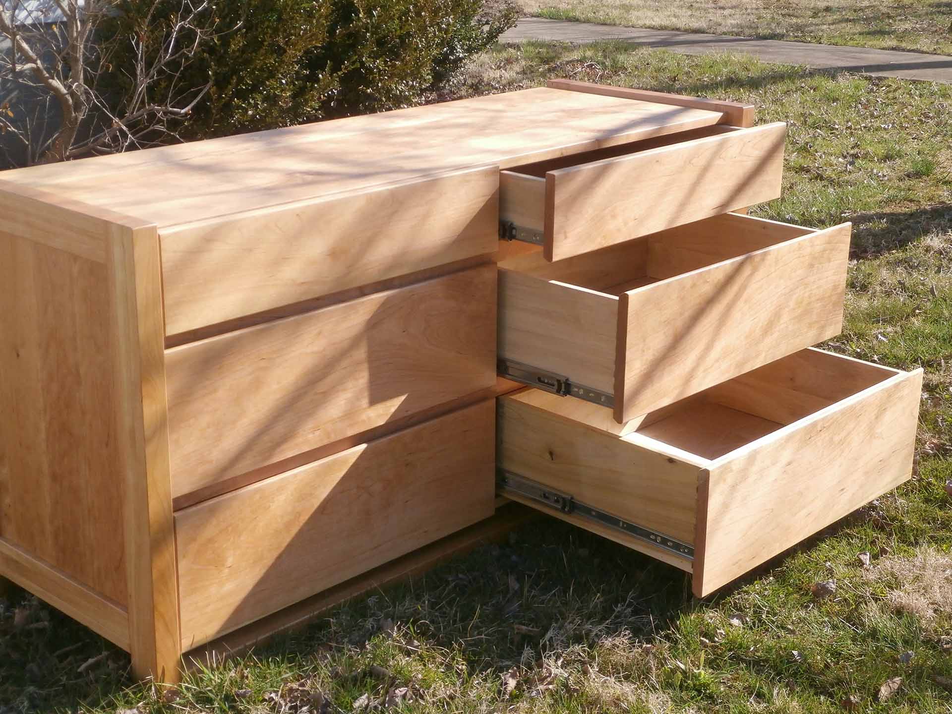 side view with three drawers extended framed dresser