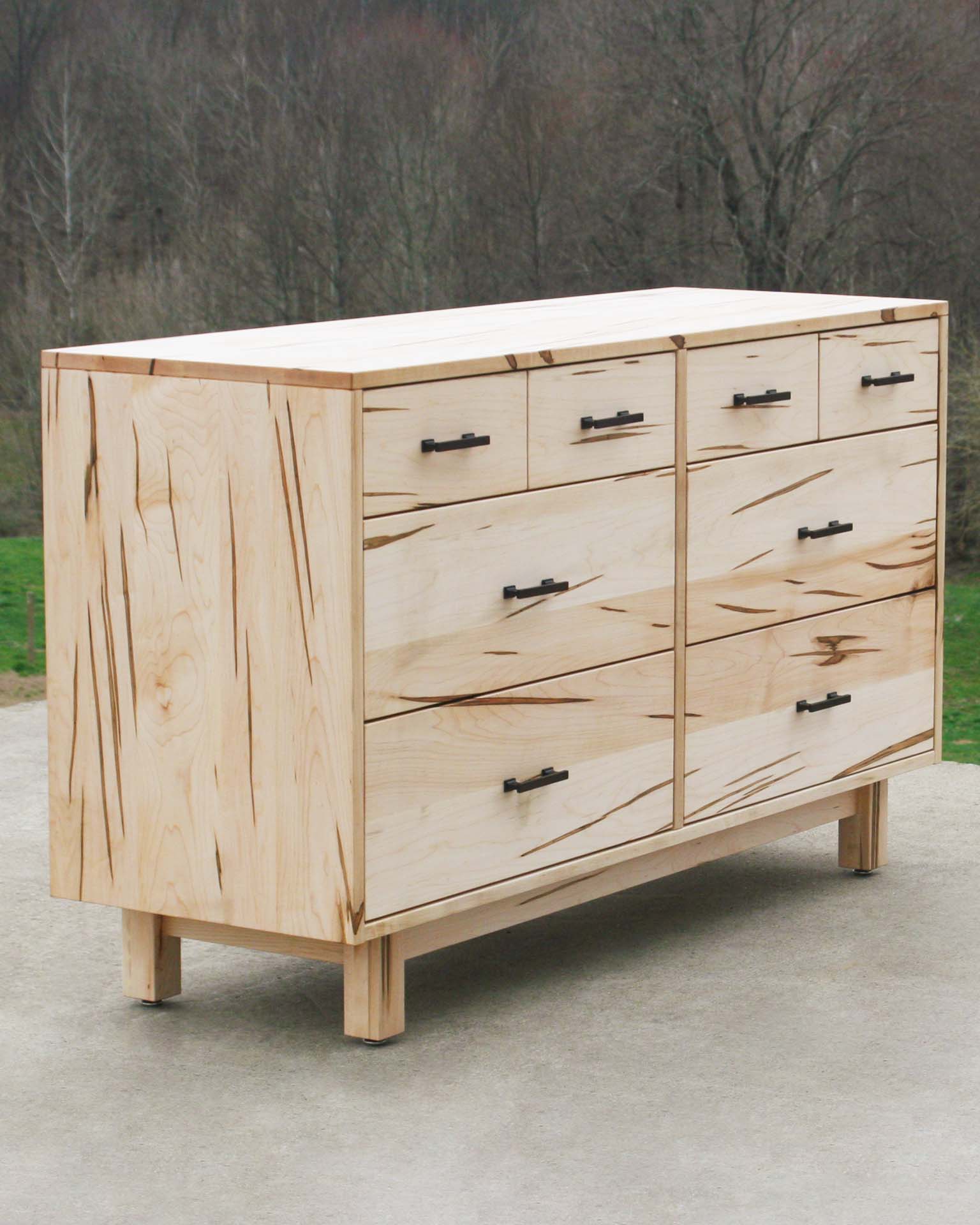 angled view wormy maple 8 drawer dresser