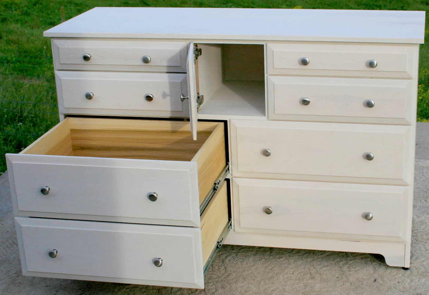 white dresser with drawers and door open