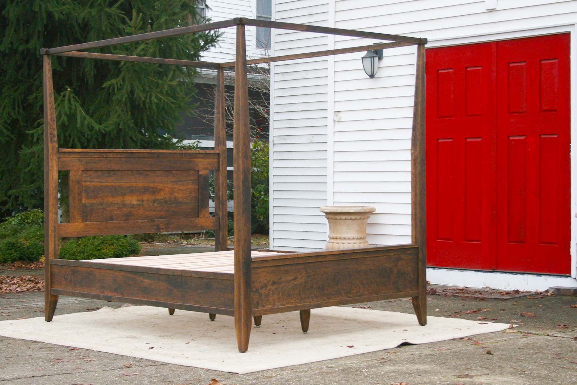 angled view wood Canopy Bed with Shaped Headboard