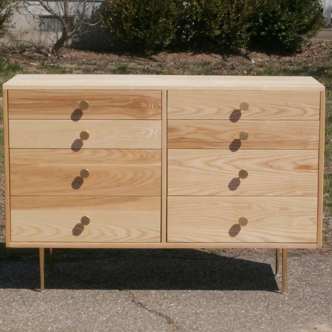 front view dresser with 8 inset drawers and mid century modern polished brass legs and drawer pulls