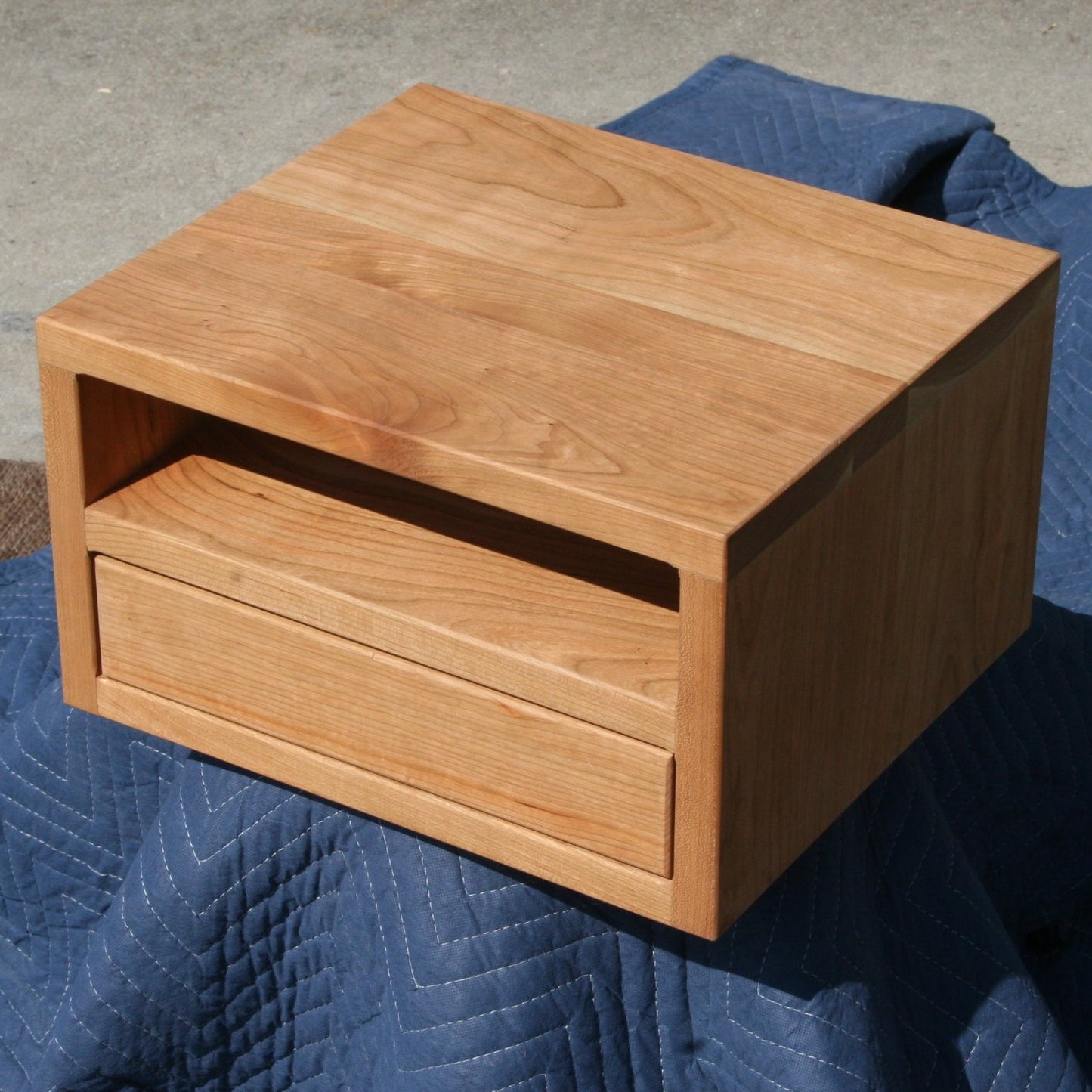 small bedside storage unit wood angled view