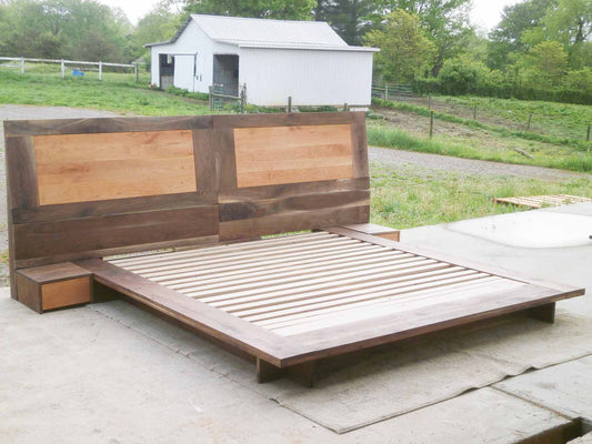 side view of a Low Platform Bed with a large headboard and side tables
