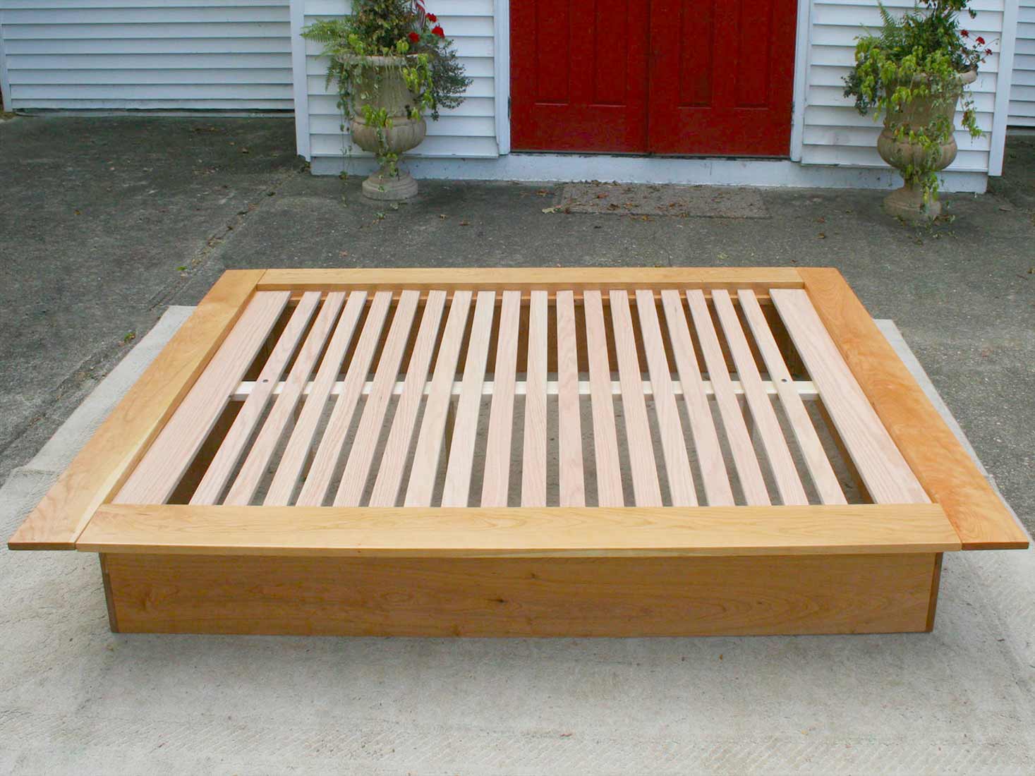 Low Platform Bed with no headboard and wide platform extensions side view