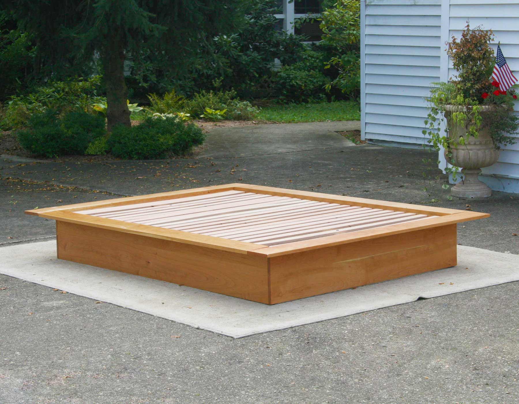 angled view Low Platform Bed with no headboard and wide platform extensions