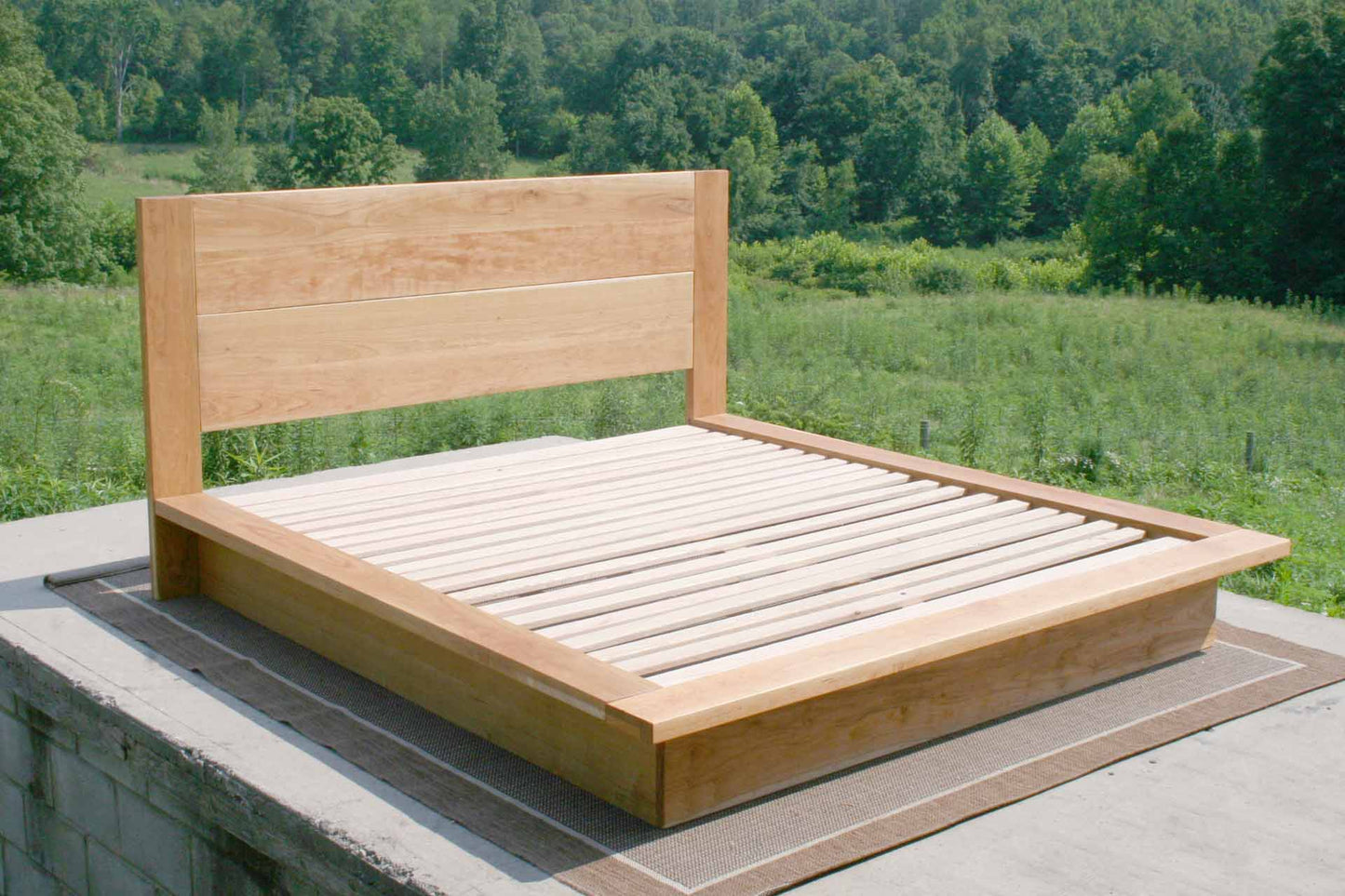 top angled view Platform bed with tall headboard and wide sides