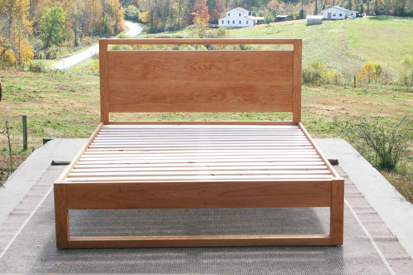 platform bed with a rail above the head board and rails at floor front view