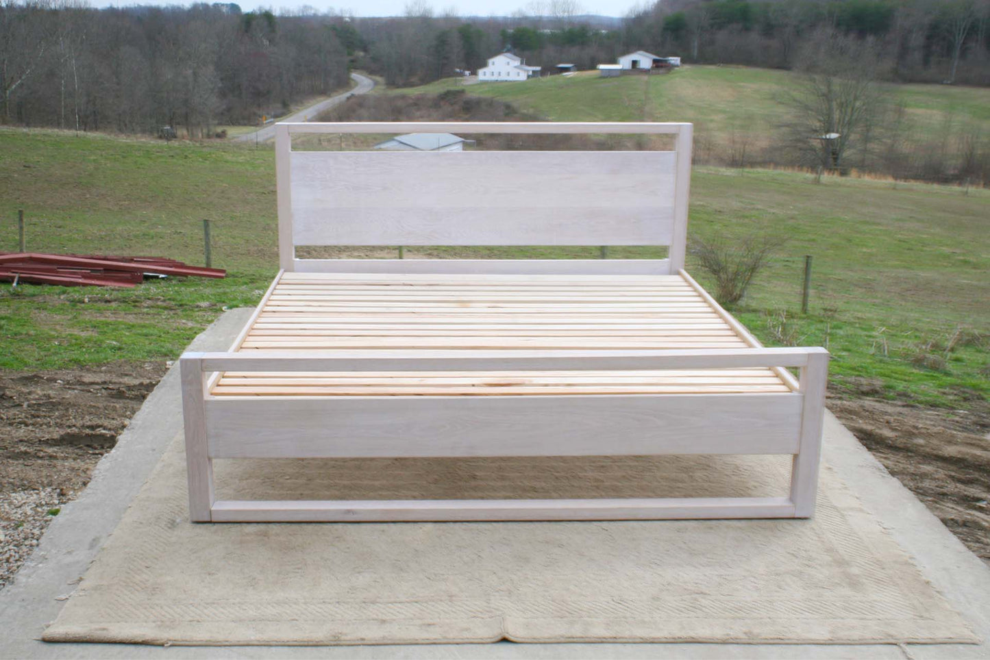 platform bed with a rail above the head board and rails at floor front view