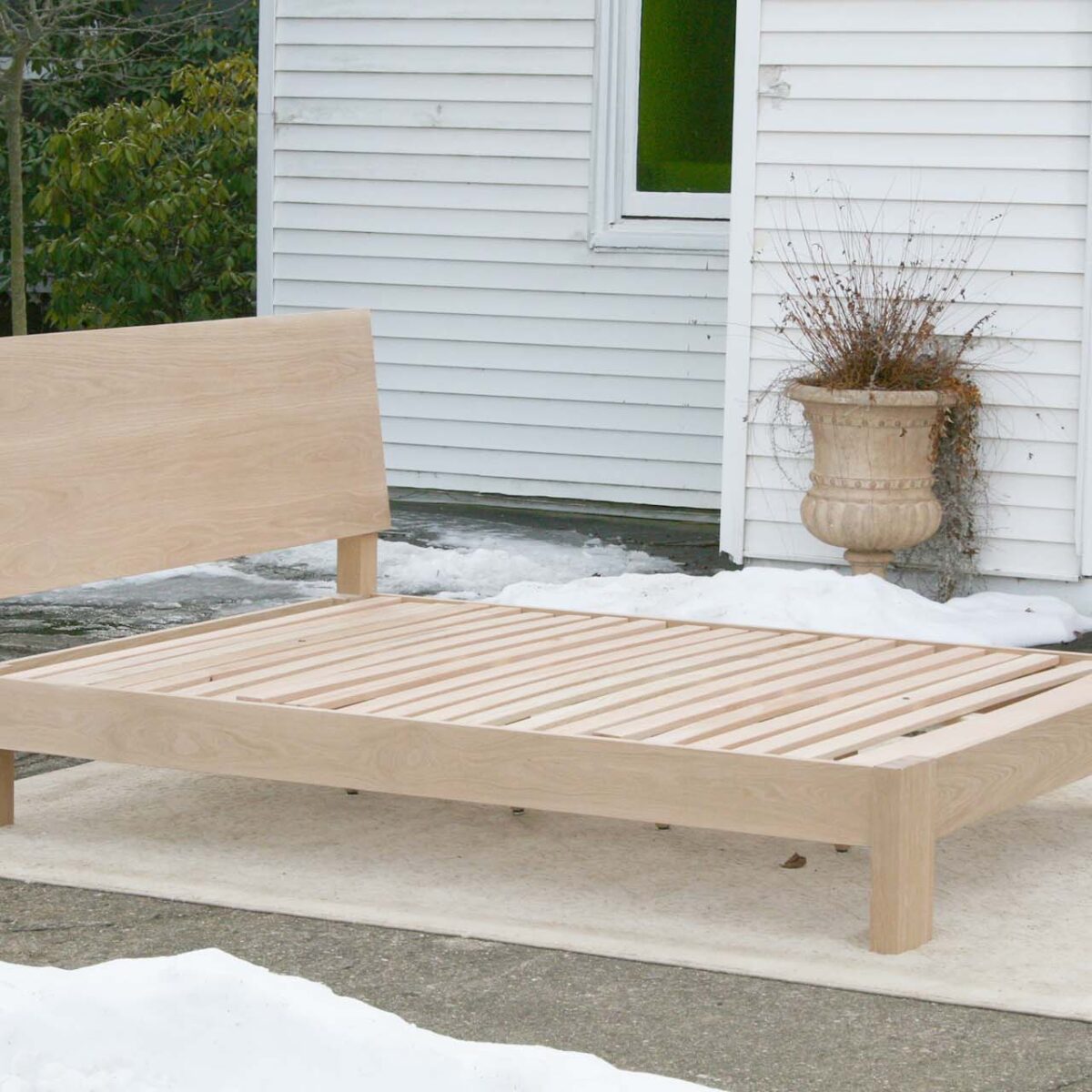 sturdy platform bed with angled headboard and wide thick posts top angled view