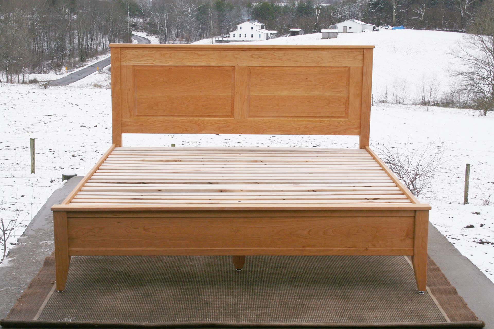 front view hardwood Platform Bed with paneled headboard and tapered post