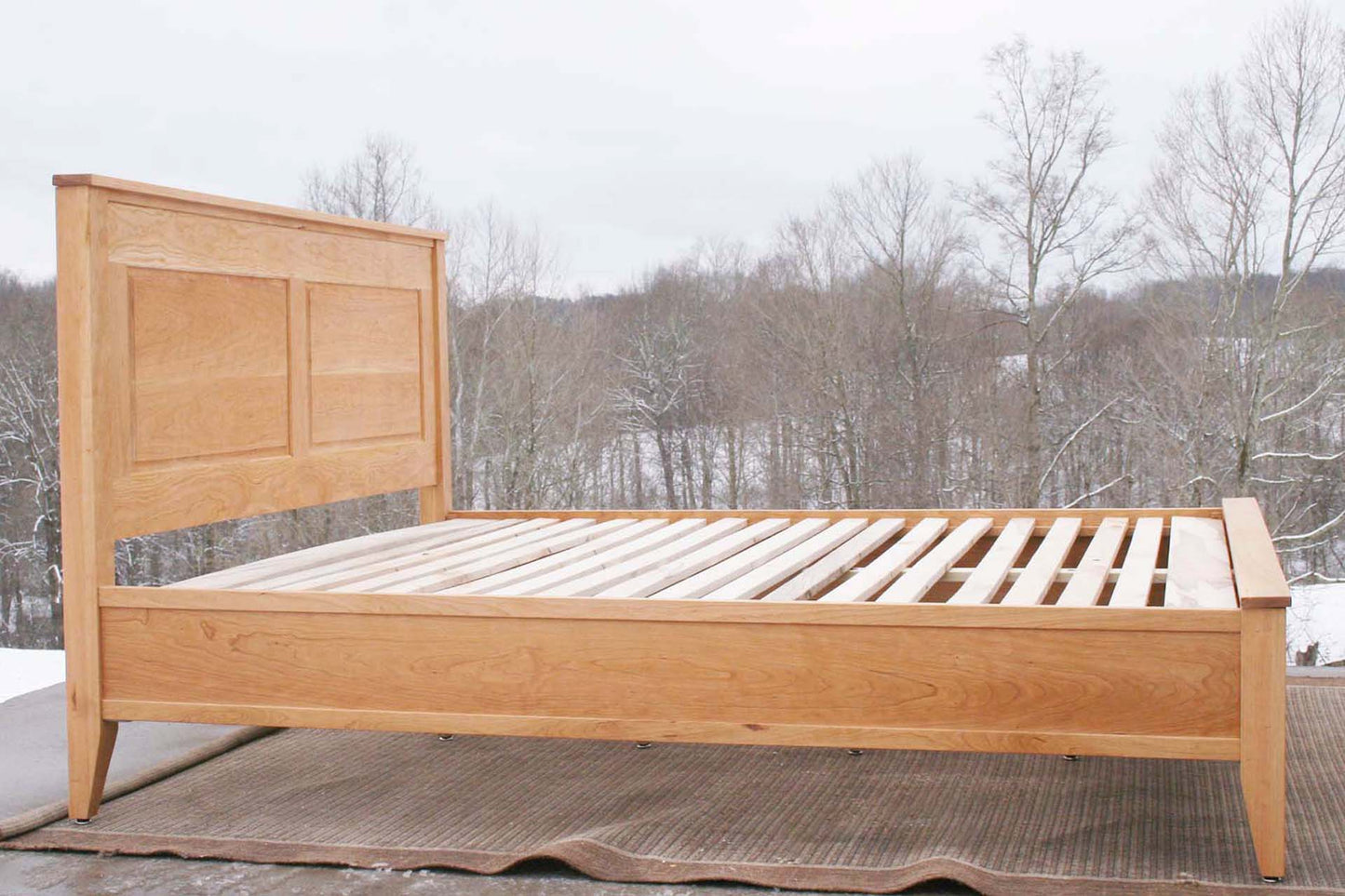 side view hardwood Platform Bed with paneled headboard and tapered post