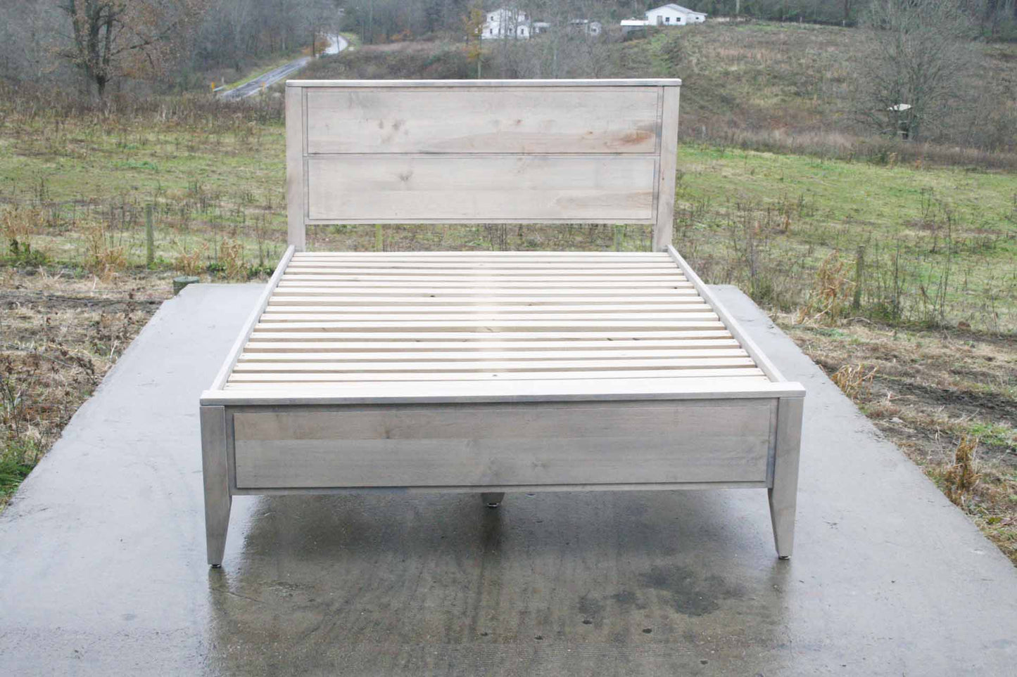 Paneled bed with platform and raised headboard front top down view