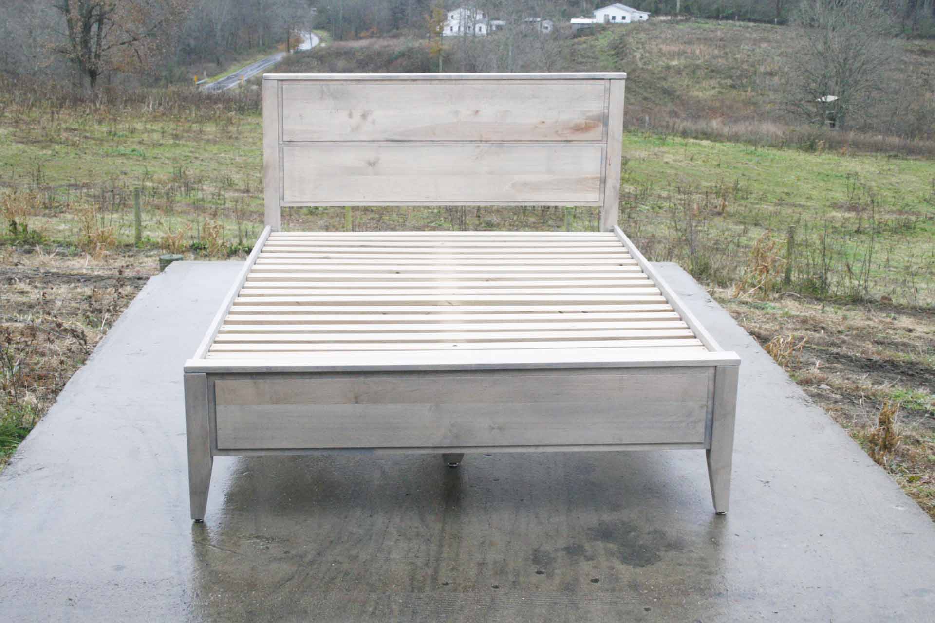 Paneled bed with platform and raised headboard front top down view