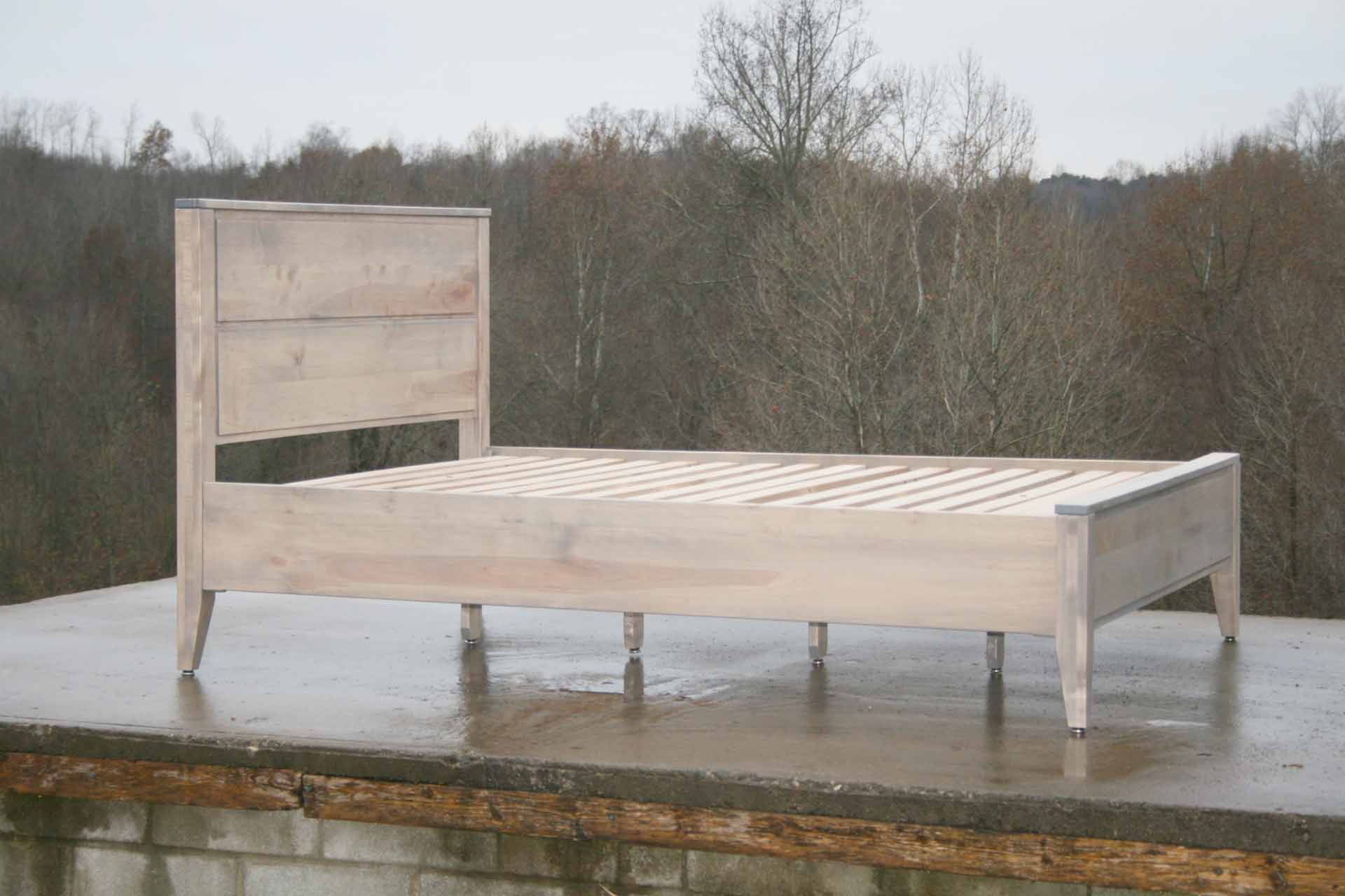 Paneled bed with platform and raised headboard white stained angled side view