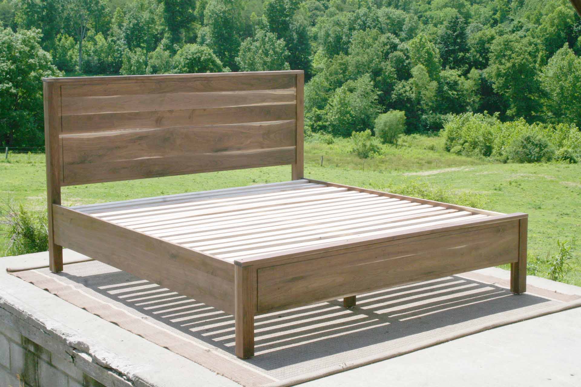 Paneled bed with platform and raised headboard angled view