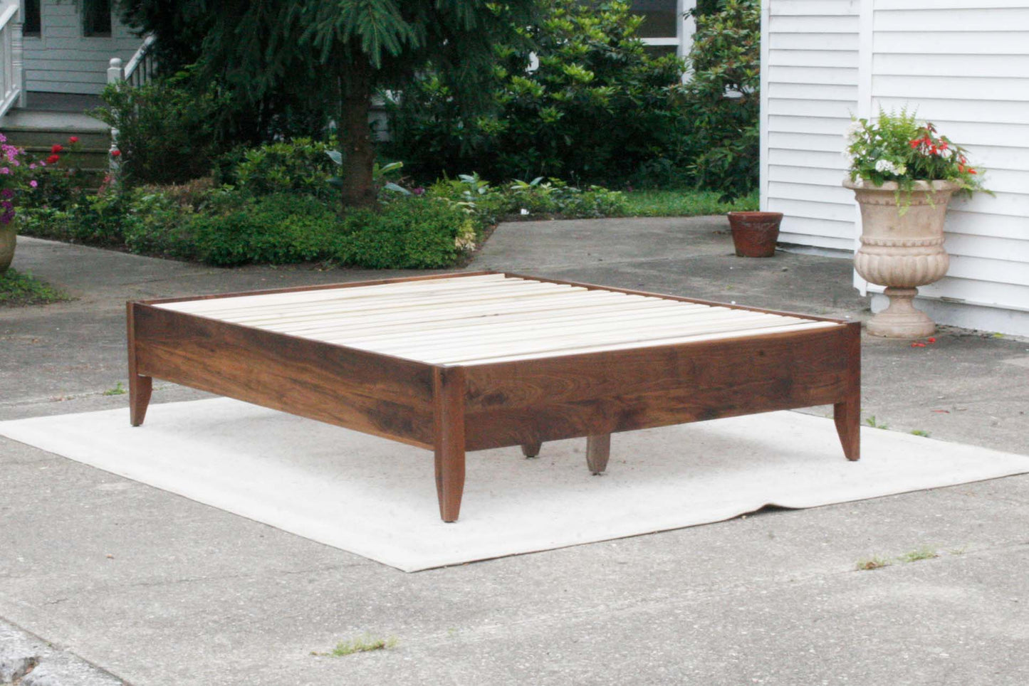 angled view walnut storage bed with 6 drawers and angled headboard