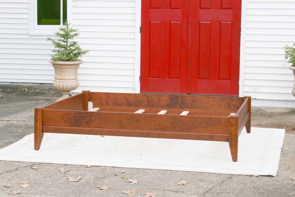 solid wood bed with trim side view